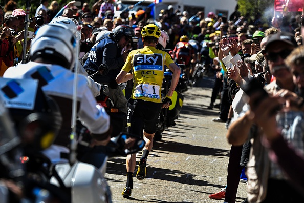Great Britain's Christopher Froome (C), wearing the overall leader's yellow jersey, runs to get a replacement bike following a fall during the 178 km twelvelth stage of the 103rd edition of the Tour de France cycling race on July 14, 2016 between Montpellier and Chalet-Reynard. / AFP / JEFF PACHOUD        (Photo credit should read JEFF PACHOUD/AFP/Getty Images)