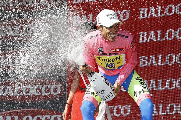 Spaniard Alberto Contador celebrates on the podium with the pink jersey on May 29, 2015 after the 19th stage of the 98th Giro d'Italia cycling race, a 236 kms leg between Gravellona Toce and Cervinia. AFP PHOTO / LUK BENIES        (Photo credit should read LUK BENIES/AFP/Getty Images)