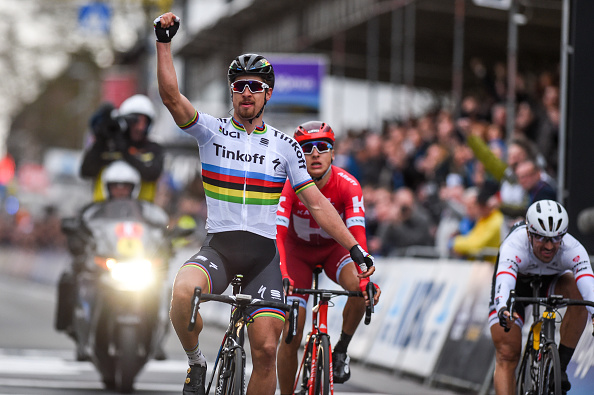 Slovakia's Peter Sagan of Tinkoff (C) celebrates as he crosses the finish line to win the 78th edition of the Gent-Wevelgem one day cycling race, on March 27, 2016 in Welvegem.  / AFP / Belga / LUC CLAESSEN / Belgium OUT        (Photo credit should read LUC CLAESSEN/AFP/Getty Images)
